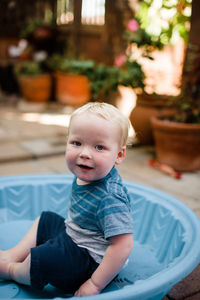 Cute baby boy sitting outdoors