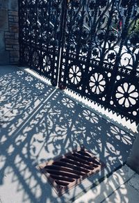 High angle view of shadow on railing against building