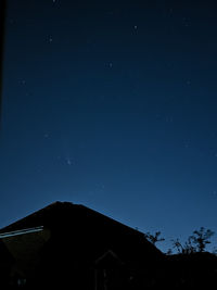 Low angle view of silhouette building against sky at night