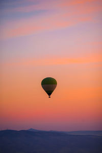 Hot air balloons against sky during sunset