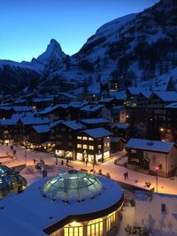 Aerial view of illuminated buildings in city at winter