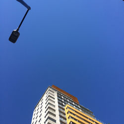 Low angle view of illuminated street light against building