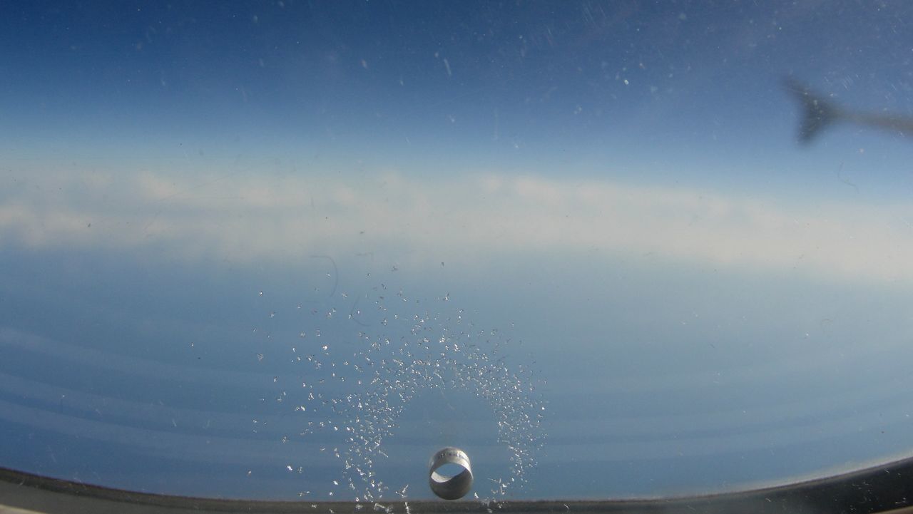 CLOSE-UP OF RAINDROPS ON WATER