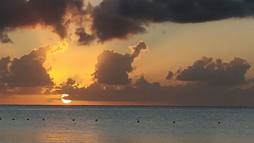 View of sea against cloudy sky during sunset