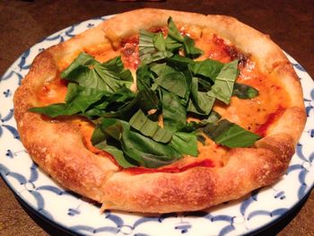 High angle view of pizza in plate on table