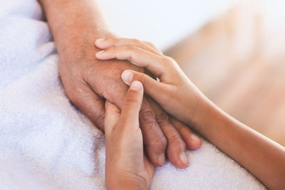 Close-up of family holding hands