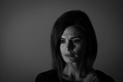 Close-up of woman against gray background