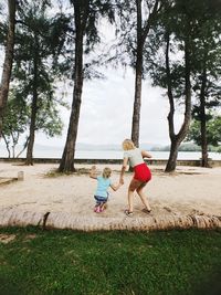 Children playing with umbrella on land