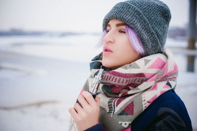 Close-up of beautiful young woman in winter