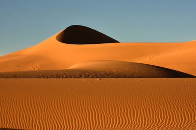Scenic view of desert against clear sky