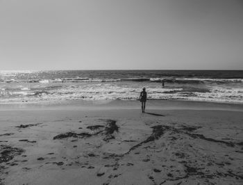 Long shadow by the atlantic ocean - scenic view of sea against clear sky