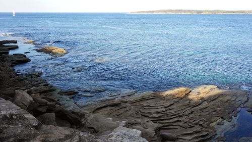 High angle view of rocks on beach against sky