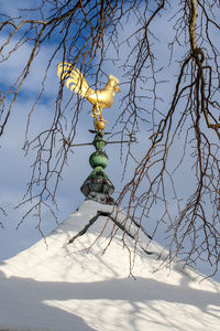 A golden rooster watches over camden harbor during a wintry maine winter. 