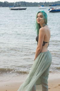 Young woman standing at beach