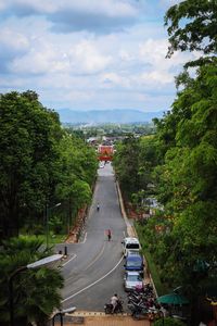 Cars on road in city against sky