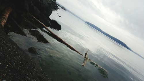 High angle view of man in sea against sky