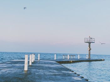 Pier over sea against clear sky