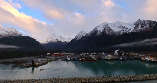 Scenic view of lake and snowcapped mountains against sky