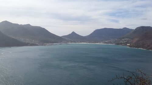 Scenic view of sea and mountains against sky