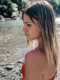 Close-up of young woman standing at beach