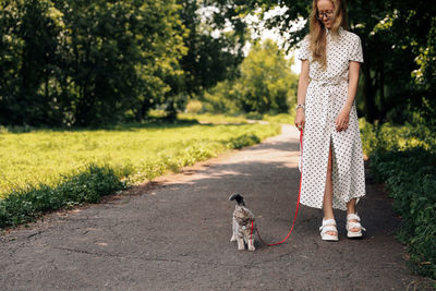 Woman walks with a kitten in the park