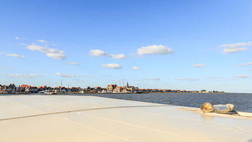 View of buildings in sea against cloudy sky