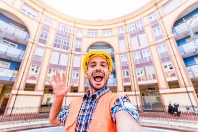 Portrait of young man in front of building