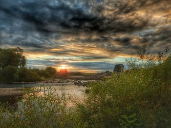 Scenic view of lake against cloudy sky