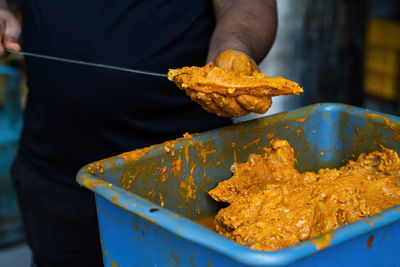 Midsection of man preparing food