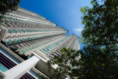 Low angle view of modern buildings against blue sky