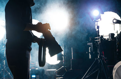 Digital composite image of man welding on stage