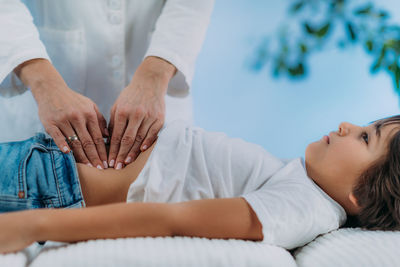 Pediatrician gastroenterologist, doing abdominal examination to a preschooler boy