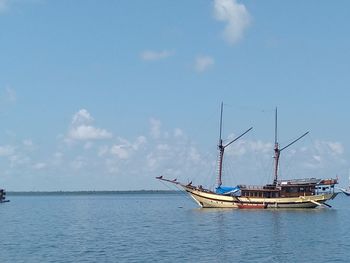 Sailboats in sea against sky