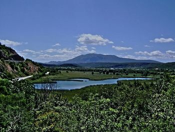 Scenic view of lake and mountains against sky