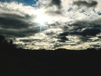 Low angle view of silhouette trees against sky