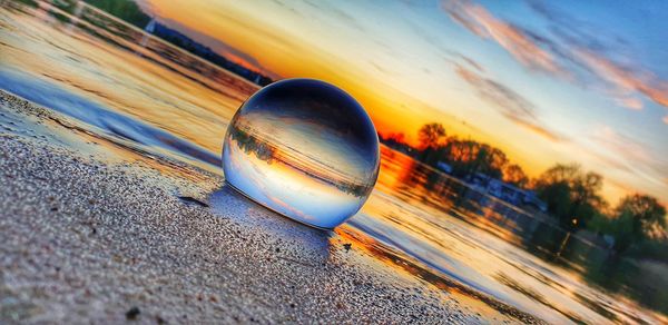 Close-up of sunglasses on beach against sky