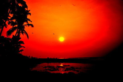 Scenic view of sea against romantic sky at sunset