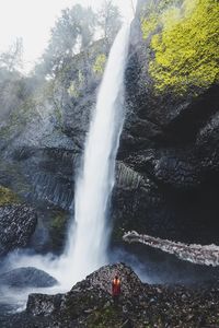 Scenic view of waterfall against sky