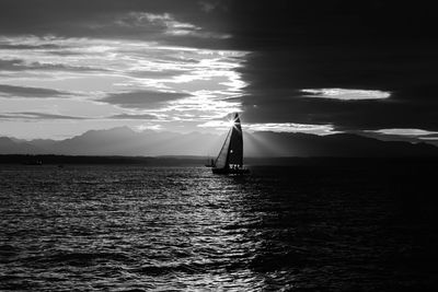 Sailboat sailing on sea against sky