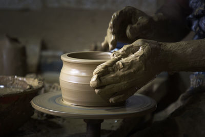 Midsection of person making pottery