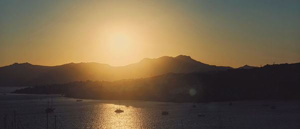 Scenic view of silhouette mountains against sky during sunset