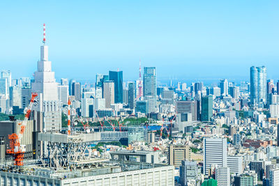 Aerial view of modern buildings in city against sky