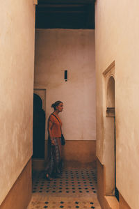 Man and woman standing by building