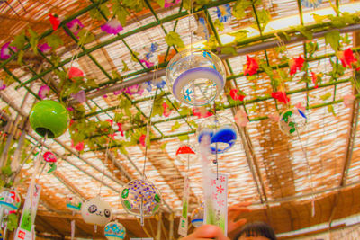 Low angle view of carousel hanging in amusement park