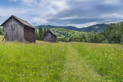 Built structure on field against sky