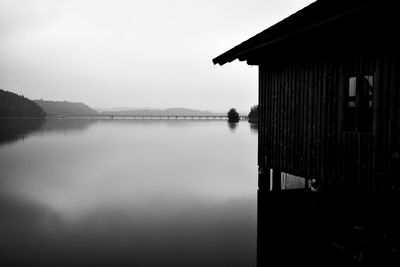 Scenic view of lake by building against sky