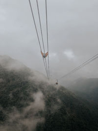 Cablecar above foggy mountains