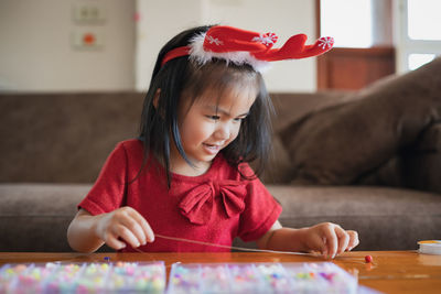 Cute girl making decoration on table