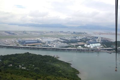 Aerial view of city against cloudy sky