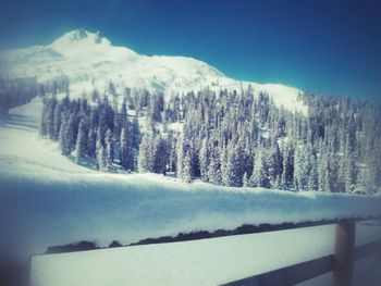 Scenic view of snow covered mountains against sky